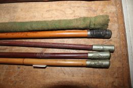 Four swagger sticks and a case