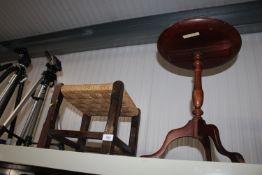 A string topped stool together with a reproduction