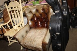 A brown leather upholstered Chesterfield style arm