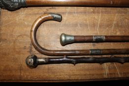 Three silver handled walking sticks