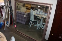 A modern framed and bevel edged wall mirror