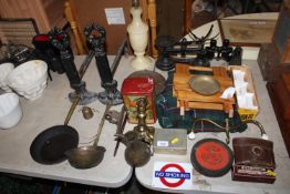 A pair of wrought iron fire dogs; scales; a brass