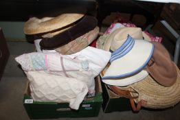 Two boxes containing various hats and cushions