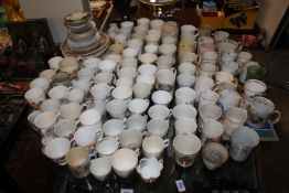 A large quantity of various commemorative mugs and