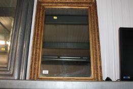 A gilt framed wall mirror