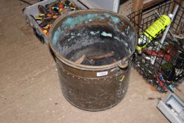 A copper coal bucket with swing handle