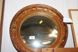 A gilt framed, convex wall mirror