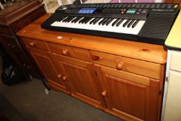 A pine sideboard fitted three drawers