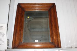 An oak framed and bevel edged wall mirror