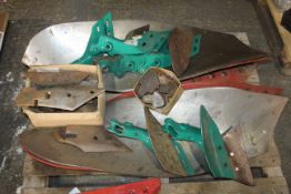 Quantity of part worn Kverneland plough mouldboards, unused skimmer brackets etc.