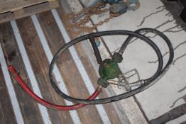 Hand fuel pump with delivery hose.