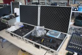Quantity of AKG DHT700 microphones and accessories contained in two flight cases.