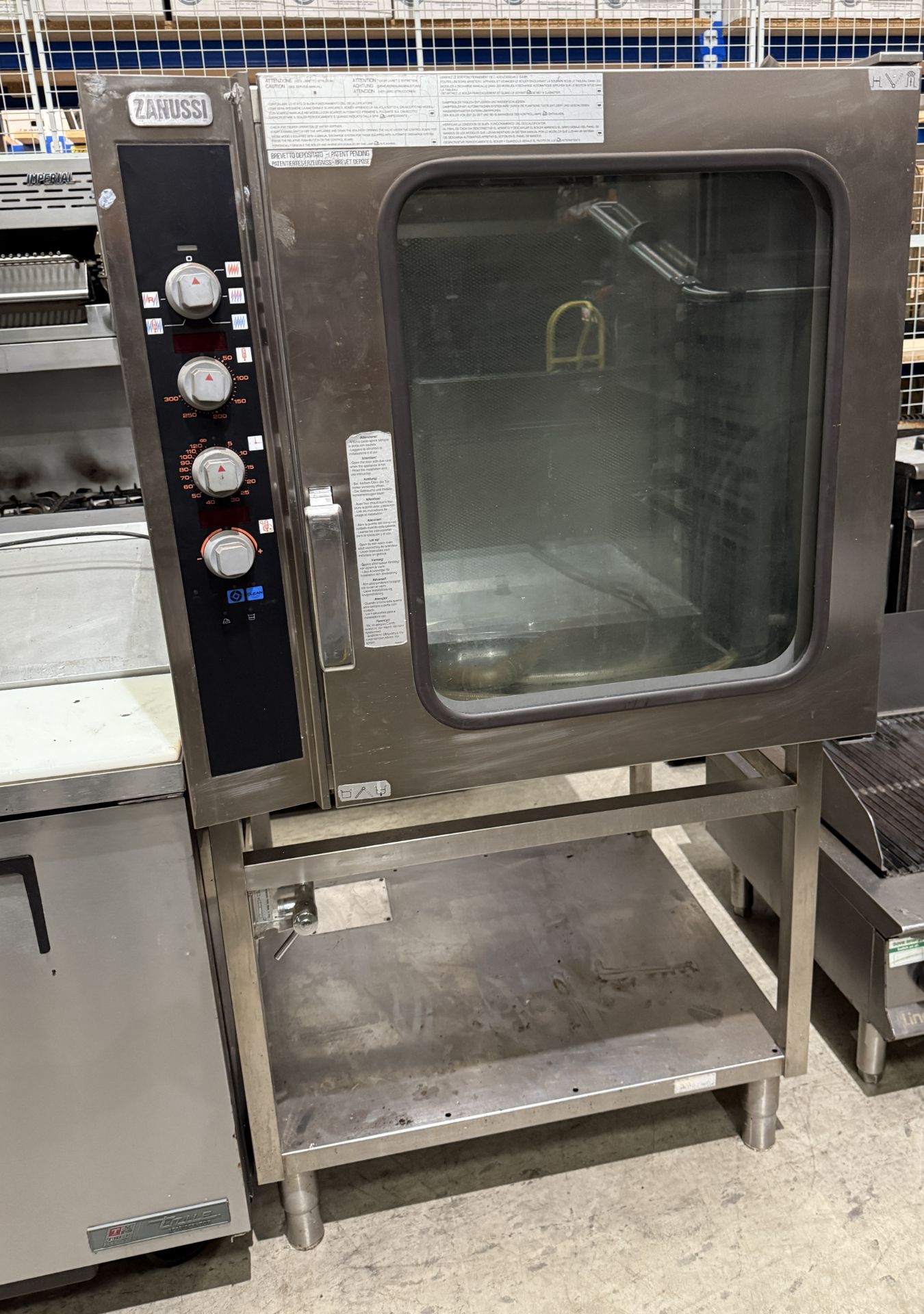 Zanussi stainless steel commercial single-door gas oven on stainless steel single shelf stand,