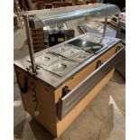 A commercial mobile Victor stainless steel warm serving counter with two sliding door cupboard and