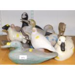 A collection of decoy style carved ducks, together with ceramic decorative birds, and animals