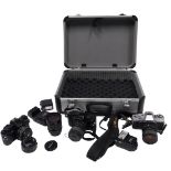 Three Minolta X-300 cameras, together with Minolta lenses, and flashes, cased.