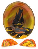 A Poole Pottery Aegean pattern oval plate or plaque, 40cm wide, and two Poole Delphis dishes. (3)