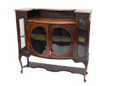 An Edwardian mahogany side cabinet, the top with a moulded edge above a recess, and two doors,