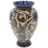 A Doulton Lambeth stoneware baluster-shaped vase, with sgraffito decoration of scrolls, flowers,
