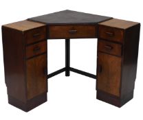 An Art Deco walnut corner desk, the central top section with a black faux leather panel, above an