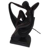 An Art Deco style plaster table lamp, modelled as a semi-clad lady, seated upon her draped robe,