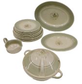 A Susie Cooper part dinner service, each piece decorated with a flower, on a pale green ground, to