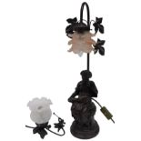 A bronze resin table lamp base, modelled in the form of a lady reading with pink frilly shade,
