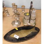 A plated five branch candelabrum, together with plated cruet set, and a brass fish, on a wooden