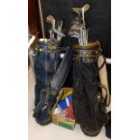 Two Titleist golf bags, containing various golf clubs.