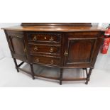 An oak bow fronted sideboard, with three central drawers, with egg and dart moulding, flanked by two