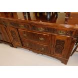 A late 19thC walnut Art Nouveau style sideboard, with two wide and two narrow drawers, flanked by