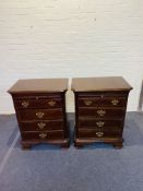 A pair of antique style bedside chests of drawers