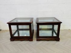 A pair of stained mahogany display end tables