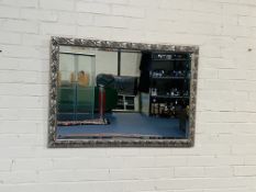 A decorative antique style silver gilt wall mirror