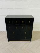 A contemporary black lacquered Chinese style medicine chest drawers