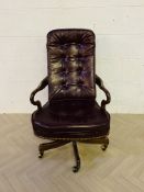 A stained walnut revolving desk chair