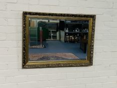 A decorative antique style gilt wall mirror