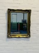 A decorative antique style gilt wall mirror