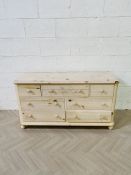 A contemporary lightly 'washed' pine chest of drawers
