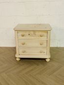 A contemporary lightly 'washed' pine chest of drawers