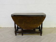 An early 18th century oak drop leaf gateleg table