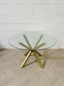 A contemporary circular plate glass top centre table