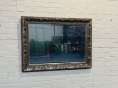 A large decorative antique style silver gilt wall mirror