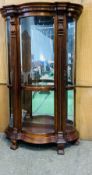 An attractive tall mahogany two door serpentine display case