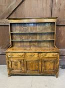 A mid 18th century oak dresser with delft rack