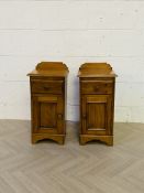 A pair of antique style pine bedside cabinets