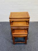 A 20th century Chinese hardwood nest of three tables