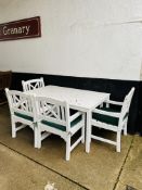 A contemporary white painted patio garden set comprising a table and four armchairs