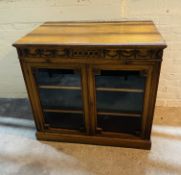 An attractive and good quality 'Adam' style solid walnut library cabinet