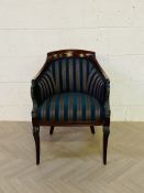 A decorative antique style upholstered open armchair